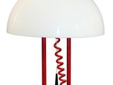 the lamp is red and white with a white shade on it