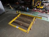 a wooden floor with a yellow frame in a warehouse