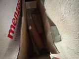a box with a hot dog inside of it on the floor