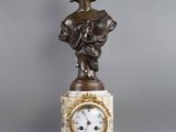 statue of a woman holding a clock on a marble base