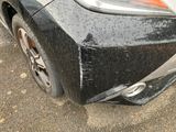 a close up of a car ' s front bumper with scratches on it