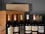 several bottles of wine are lined up on a shelf in front of a wooden box