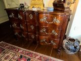 a dresser with a mirror on top of it in a room