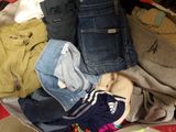 a suitcase full of clothes that is sitting on the floor
