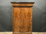 an antique walnut chest of drawers with marble top
