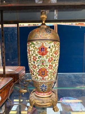 a vase that is on a glass table in a room
