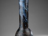 a black and blue vase sitting on a table