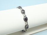 a close up of a bracelet on a napkin on a table