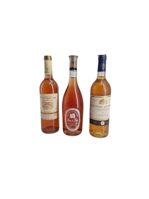 three bottles of wine sitting next to each other on a white surface