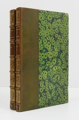 un livre à la couverture verte posé sur une table blanche