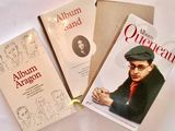 three books are sitting on a table with a white table cloth
