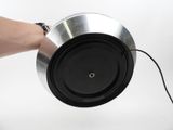 a person that is holding a metal object in their hand