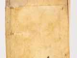 an old book sitting on top of a table next to a white wall