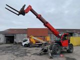 a red crane that is sitting on top of a truck