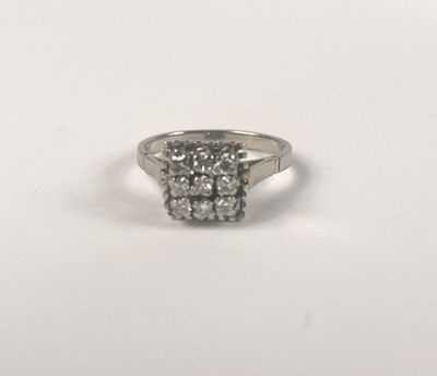 a close up of a diamond ring on a white surface