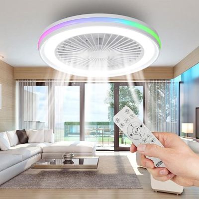 a person holding a remote control in front of a living room