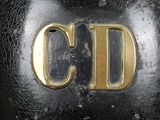 a close up of a gold letter on a black bag
