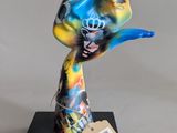 a colorful sculpture of a hand holding a blue toothbrush