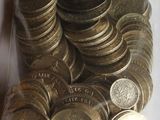 a lot of coins in a plastic bag on the table