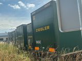 a train that is going down the tracks in the grass