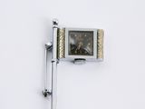 a small clock mounted to the side of a wall