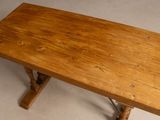 a wooden table with a wooden top on a white floor