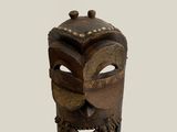 a close up of a wooden mask on a white background