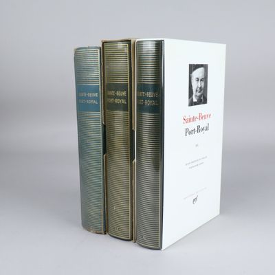 three books are stacked on top of each other on a table