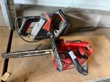 two chainsaws that are sitting on the floor