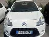 a picture of a small white car parked in a parking lot