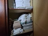 many folded towels on a shelf in a closet