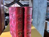 two red books sitting on a yellow table