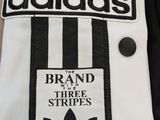 a black and white striped shirt with a black and white logo on it