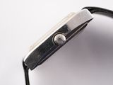 a close up of a watch on a white surface