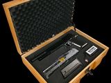 a wooden case with a gun in it on a black background