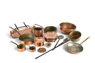 a lot of copper pots and pans on the table