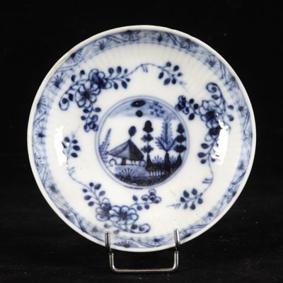 blue and white plate with a scene of a man and a woman in a boat