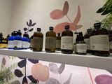 many bottles of liquid on a shelf in a room
