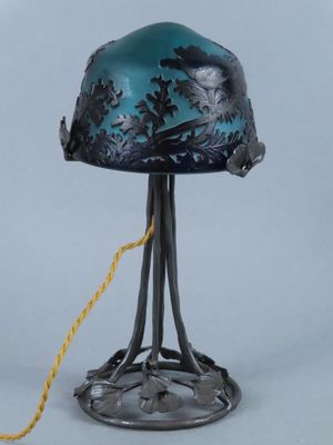 an old fashioned lamp with a blue glass shade and a yellow cord