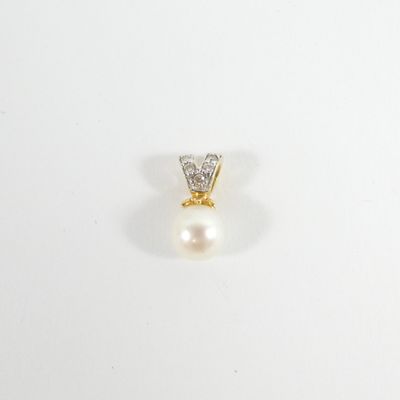 gros plan d'une bague en perles et diamants sur une surface blanche