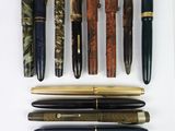 a lot of pens that are lined up on a table