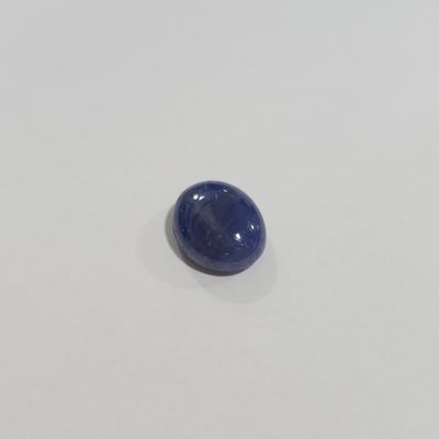 a close up of a blue stone on a white surface