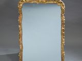 an antique gold framed mirror with a blue glass in the middle