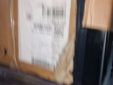 someone holding a piece of plastic wrapped in plastic with a barcode on it