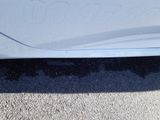 a close up of a car ' s door handle with a sticker on it