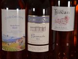 several bottles of wine are lined up on a shelf