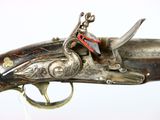an old gun with a red and white tag on it