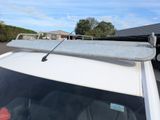 a surfboard on top of the roof of a car