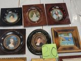 a lot of framed pictures on a table with a price tag