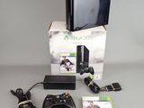 a video game console and a game controller on a table